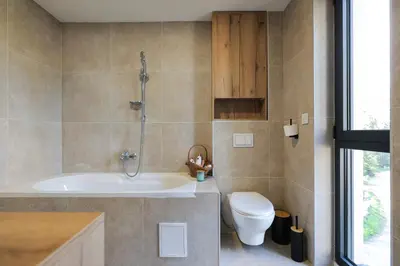 a bathroom with a tub and a toilet and a sink at Viva Vlasic - Apartman i vikendica in Šišava