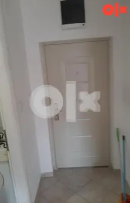 a room with a white door with a television on it at Stan na Adi in Ivišovo Greblje