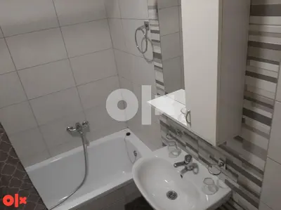 a bathroom with a sink and a shower and a tub at Stan na Adi in Ivišovo Greblje