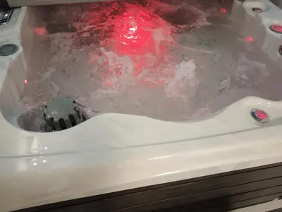 a bath tub filled with water with a red substance at SPA APARTMAN Prijedor in Prijedor
