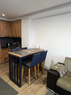 a living room with a table and chairs and a couch at Vlašić Grand View in Vlasic