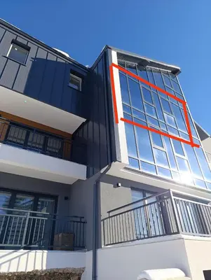 a building with a red stripe on the side of it at Vlašić Grand View in Vlasic