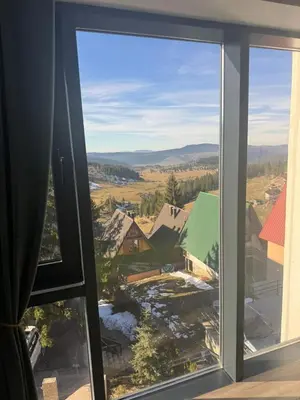 a window with a view of a town at Vlašić Grand View in Vlasic