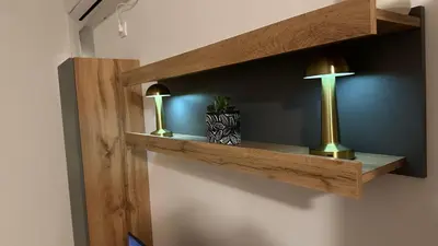 a shelf with a cross and a lamp on a wall at Sky View - Apartment & GARAGE, Banja Luka in Banja Luka