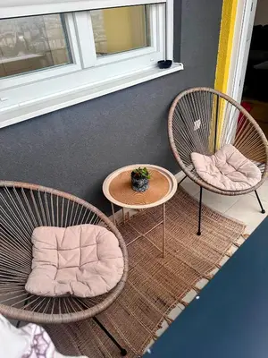 two chairs and a table with a potted plant on it at Sky View - Apartment & GARAGE, Banja Luka in Banja Luka