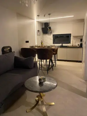 a living room with a couch and a table at Relax house - Šumska vila romanticni spa apartman sa djakuzijem in Banja Luka