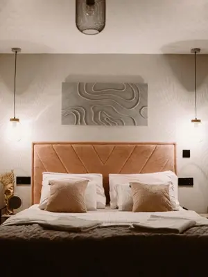 a bedroom with a large bed with a wooden headboard at Relax house - Šumska vila romanticni spa apartman sa djakuzijem in Banja Luka