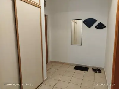 a hallway with a mirror and a tile floor at Gold Mejdan in Banja Luka