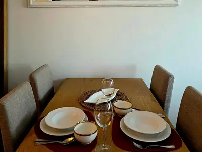 a wooden table with plates and wine glasses on it at Novicasa in Železnička Stanica Incel