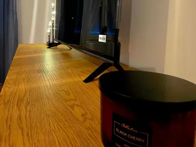 a table with a black bucket on top of a wooden floor at Novicasa in Železnička Stanica Incel