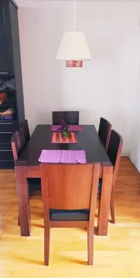 a dining room table with a black table and chairs at Connect 4 - Vlašić Vikendica in Šišava