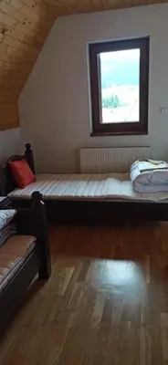 a room with two beds and a window at Connect 4 - Vlašić Vikendica in Šišava