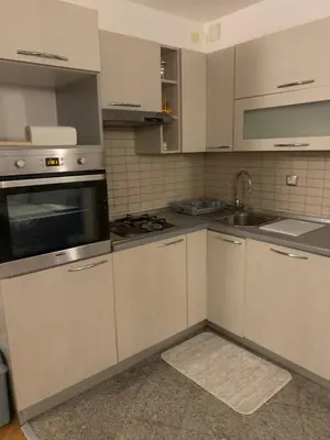 a kitchen with white cabinets and a sink at Golden Lilly Apartment in Bihać