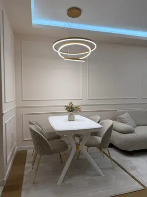 a dining room with a white table and chairs at Palata Royal Banja Luka Luxury Apartment in Banja Luka