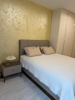 a bedroom with a bed and a table with a lamp at Palata Royal Banja Luka Luxury Apartment in Banja Luka