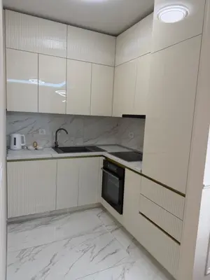 a kitchen with white cabinets and a sink and a dishwasher at Palata Royal Banja Luka Luxury Apartment in Banja Luka