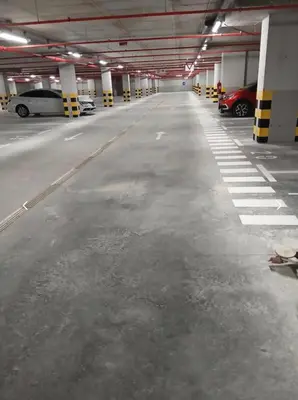 an empty parking garage with cars parked in it at Palata Royal Banja Luka Luxury Apartment in Banja Luka