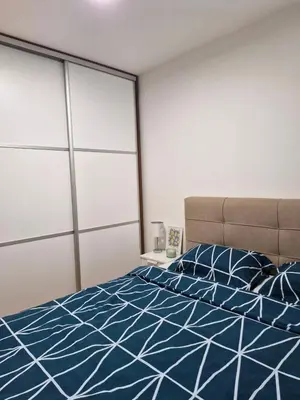 a bedroom with a bed with blue and white sheets at Pollaris in Banja Luka