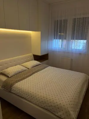 a bedroom with a large bed with a window at Aurelia Apartmani - Banja Luka-Borik in Banja Luka