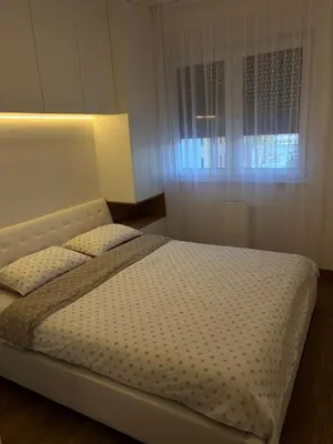a bedroom with a large bed with a window at Aurelia Apartmani - Banja Luka-Borik in Banja Luka