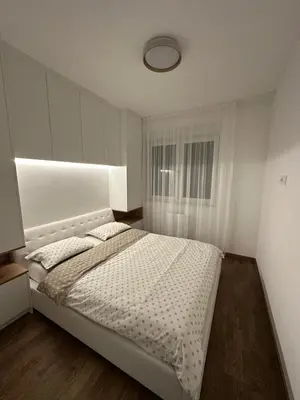 a bedroom with a white bed and a window at Aurelia Apartmani - Banja Luka-Borik in Banja Luka