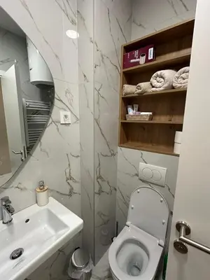 a bathroom with a white toilet and a sink at Aurelia Apartmani - Banja Luka-Borik in Banja Luka