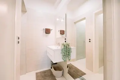a bathroom with a sink and a mirror at Studio apartman NINA in Livno