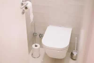 a white toilet in a bathroom with a toilet paper roll at Studio apartman NINA in Livno