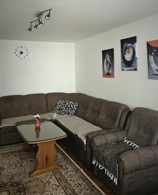 a living room with a couch and a coffee table at Stan na dan - Apartman Centar Kakanj in Kakanj