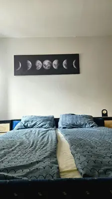 a bedroom with a bed with planets on the wall at Stan na dan - Apartman Centar Kakanj in Kakanj