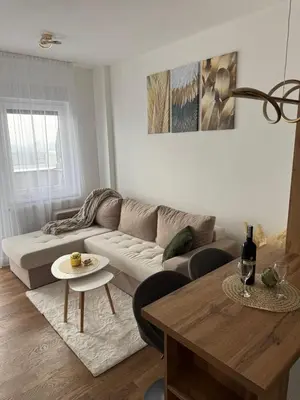 a living room with a couch and a table at Cozy apartment Banja Luka in Budžak