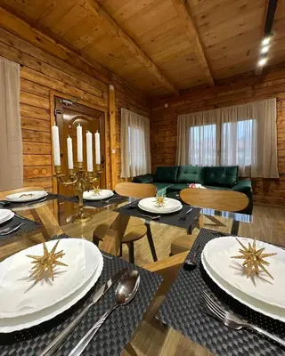 a living room with a table and a couch at Green District - Riverside Luxury Lodge in Banja Luka