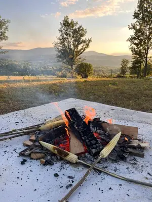 a bonfire on a table in a field at Brvnara Duga njiva Banjaluka in Čelinac