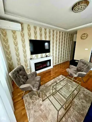 a living room with two chairs and a fireplace at Panorama in Pištelići