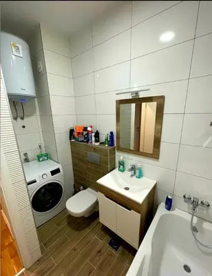 a bathroom with a sink toilet and a washing machine at Panorama in Pištelići