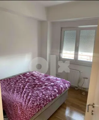 a bedroom with a purple bed in a room at Panorama in Pištelići