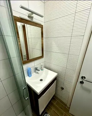 a bathroom with a sink and a mirror and a shower at Panorama in Pištelići