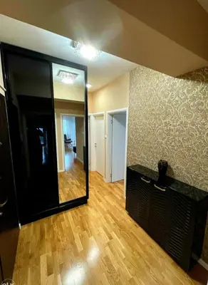 a living room with a mirror and a wooden floor at Panorama in Pištelići
