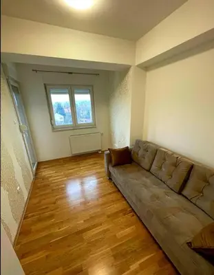 a living room with a couch in the middle of a room at Panorama in Pištelići