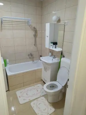 a bathroom with a toilet and a tub and a sink at Apartman Harmony N&D in Starčevica