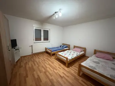 a room with two beds and a tv in it at Sobe DANA in Teslić