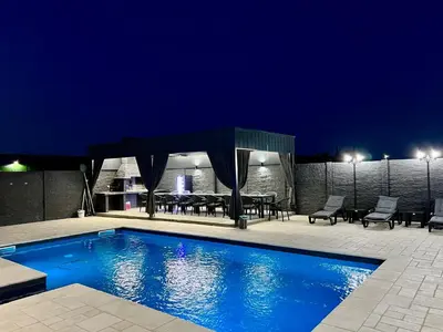 a swimming pool with a gazebo at night at Villa Sunčani Raj in Gradačac