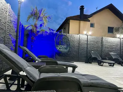 a group of chairs sitting on a patio with a fence at Villa Sunčani Raj in Gradačac