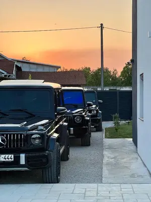 two jeepneys parked in a parking lot at Villa Sunčani Raj in Gradačac