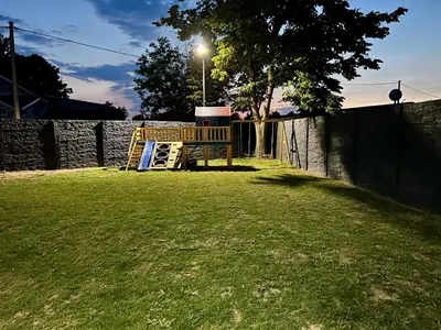 a playground in a yard with a street light at Villa Sunčani Raj in Gradačac