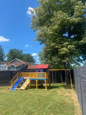 a playground with a slide in a yard at Villa Sunčani Raj in Gradačac