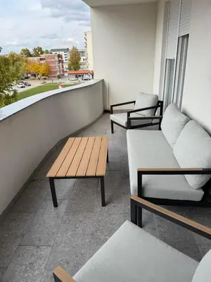 a balcony with couches and tables on a building at Apartman welsh in Bugojno