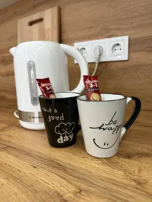 two coffee mugs with have a good day written on them at Apartman welsh in Bugojno