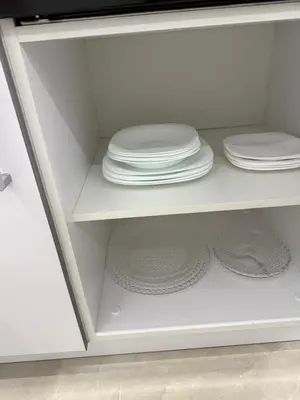 a white cabinet with plates and dishes on it at Apartman welsh in Bugojno