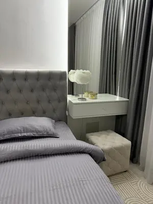 a bedroom with a bed and a table with a lamp at Apartman welsh in Bugojno